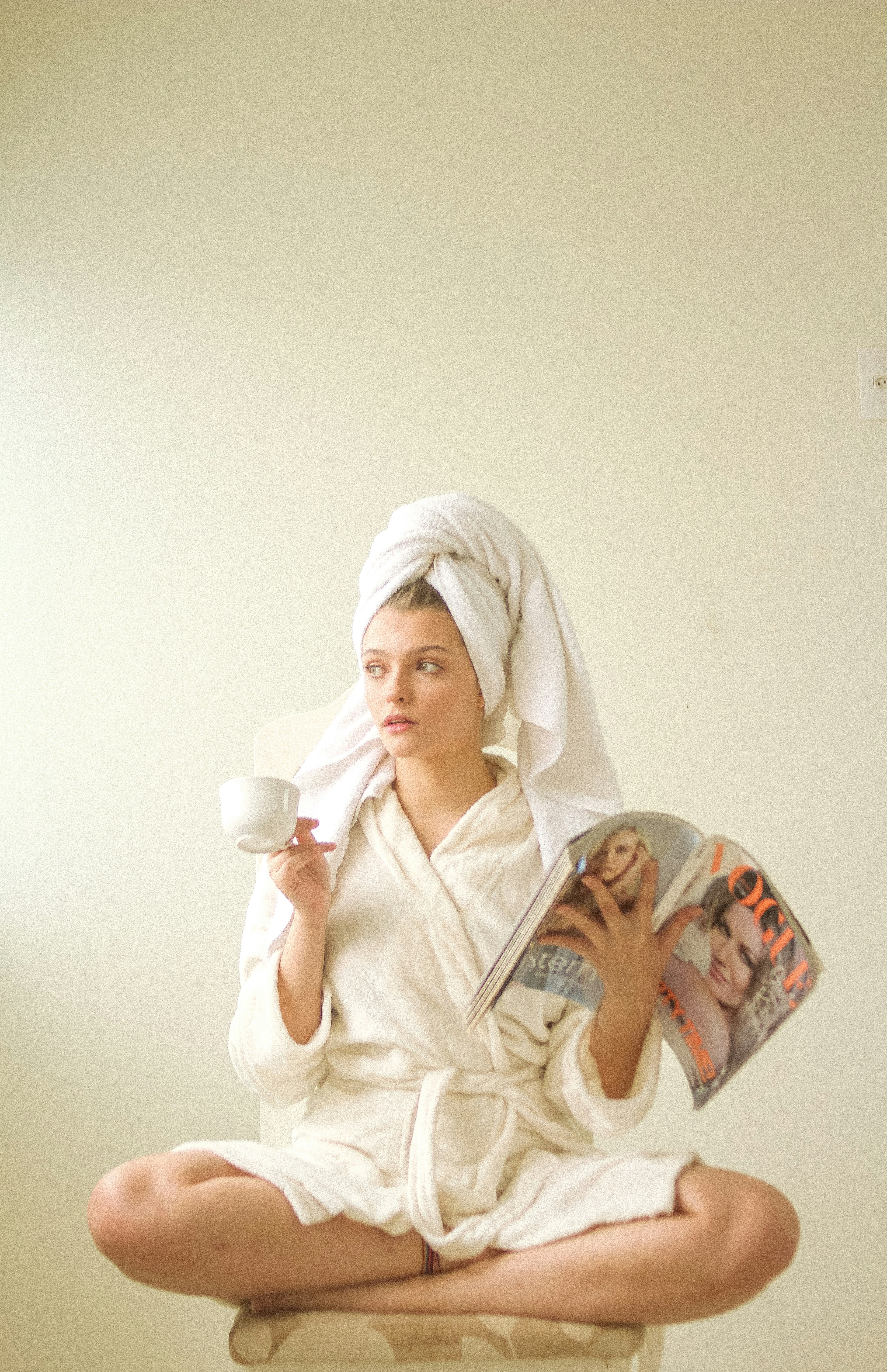 woman in white hijab holding white ceramic mug